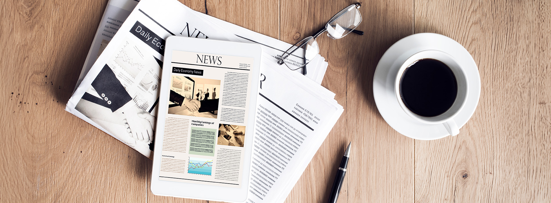 The image shows a tabletop with various items including a coffee cup, papers, and a magazine, suggesting a workspace or study area.