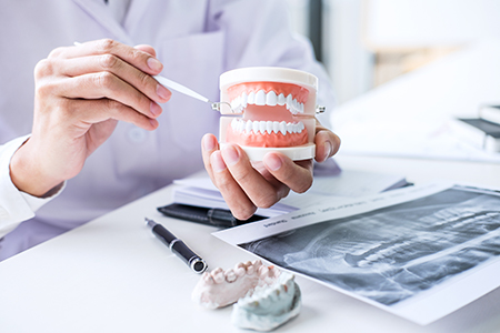 The image shows two photographs side by side  on the left, a dental professional examines a patient s teeth using a magnifying glass  on the right, the same professional holds a cup with a tooth implant and tools, indicating a focus on dental care and dental procedures.